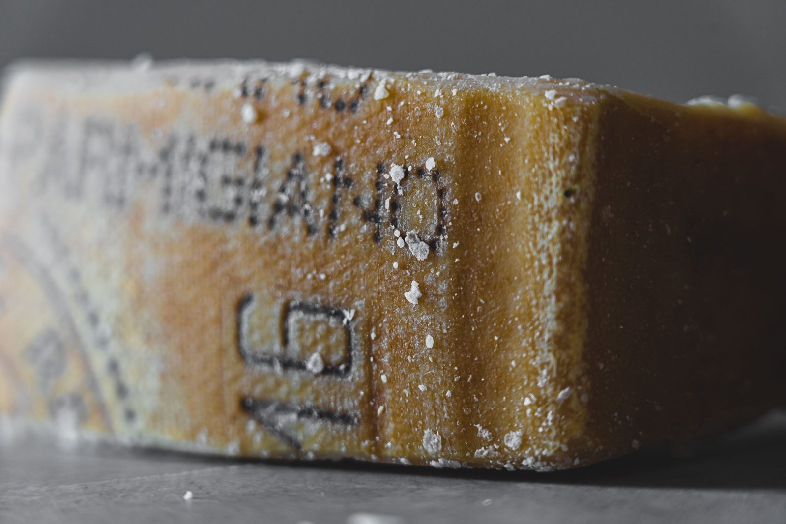 Close-up of a Parmigiano Reggiano rind with its pin-dotted lettering
